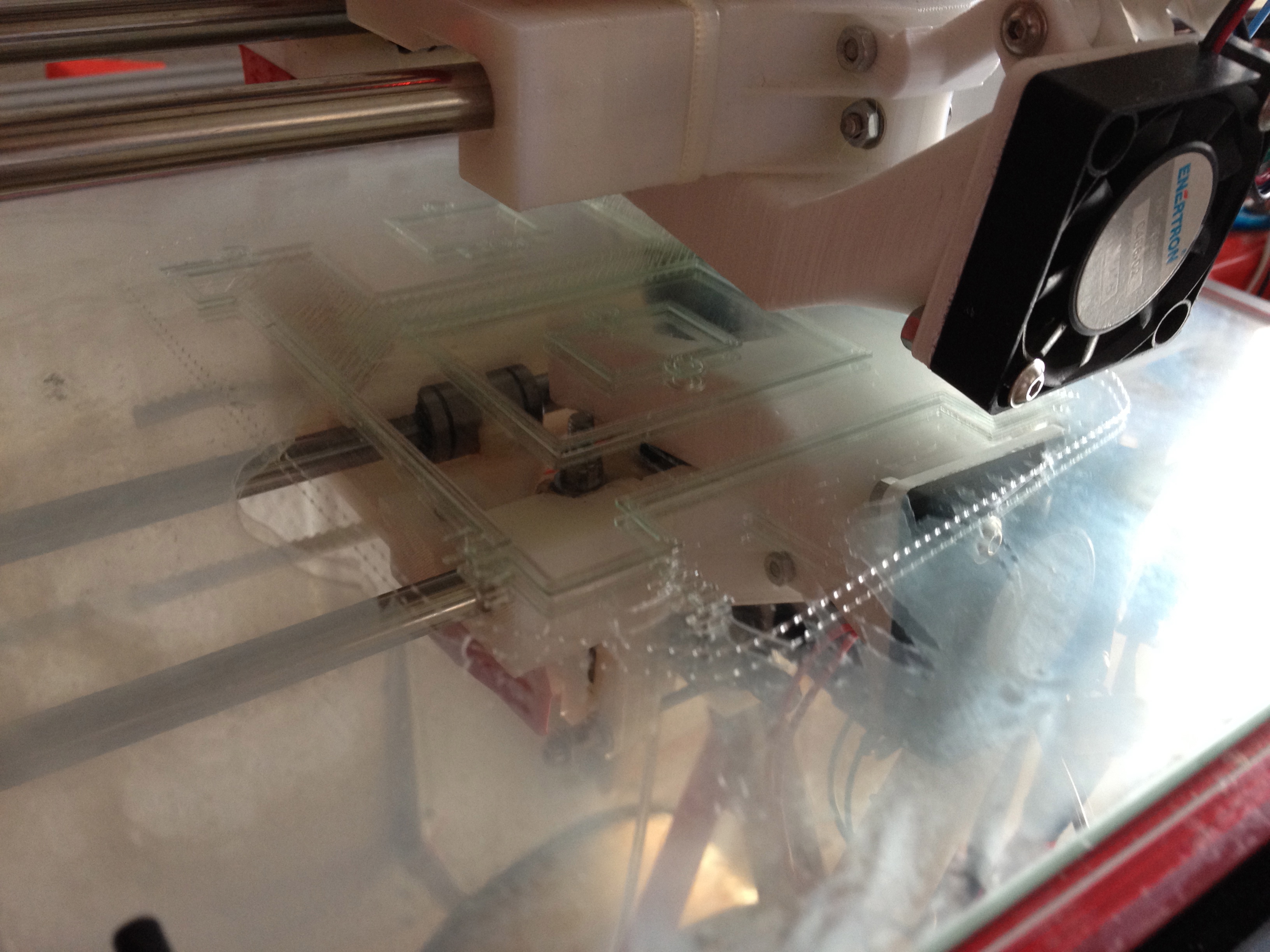 A 3d printer printing on a glass sheet